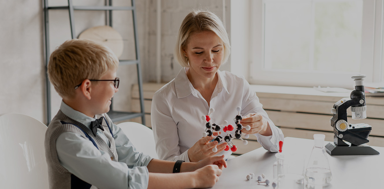 Female science tutor in Oakland studying chemistry with student