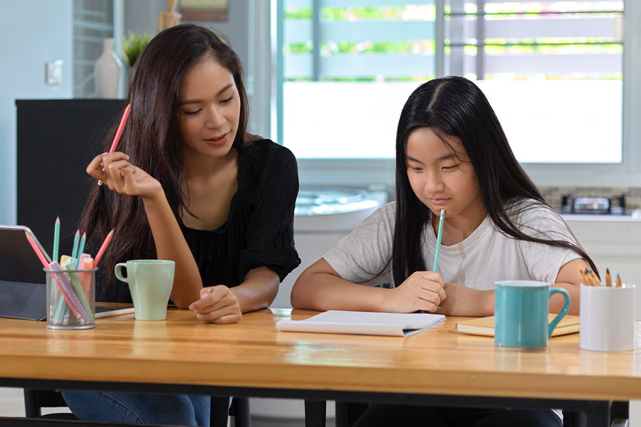 student and tutor together at a desk in Oakland